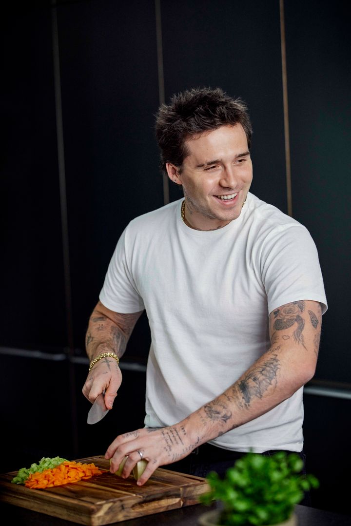 Brooklyn Beckham posing with some chopped vegetables