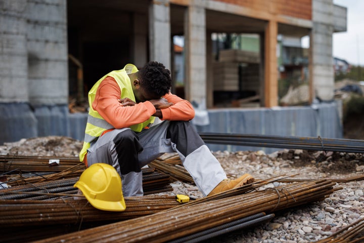 Exhausted construction worker taking a break at construction site