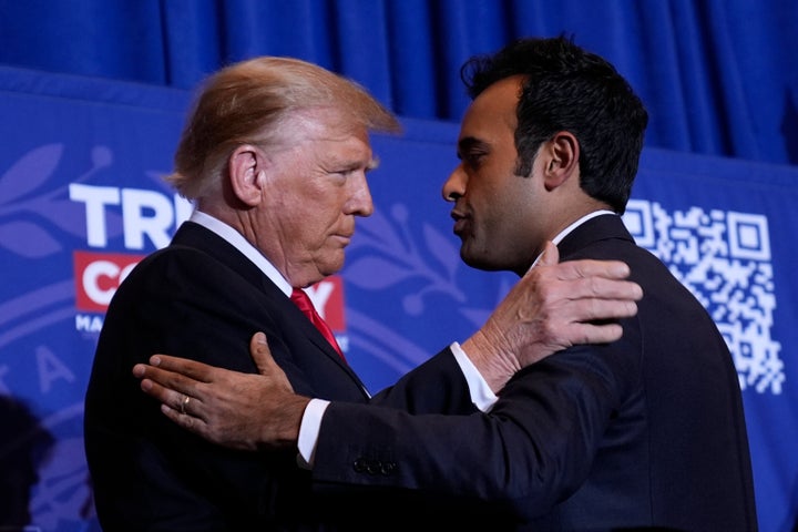 Republican presidential candidate former President Donald Trump embraces former candidate Vivek Ramaswamy at a campaign event in Atkinson, New Hampshire, on Jan. 16, 2024.