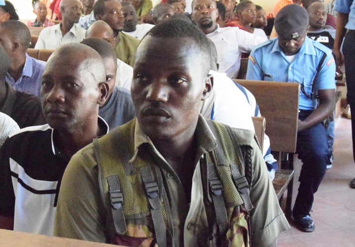 Cult preacher Pastor Paul Mackenzie, left, sits at the Shazu Law Courts in Mombasa town for the ruling of an application which had been filed by the prosecution demanding six months to continue holding him and his co-accused, Tuesday Jan. 9, 2024.