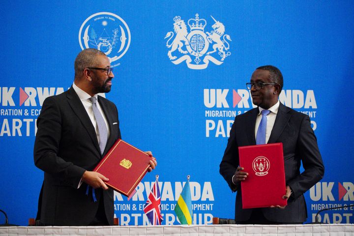 Britain's Home Secretary James Cleverly, left, and Rwandan Minister of Foreign Affairs Vincent Biruta pose for pictures after signing a new treaty in Kigali, Rwanda, in December.