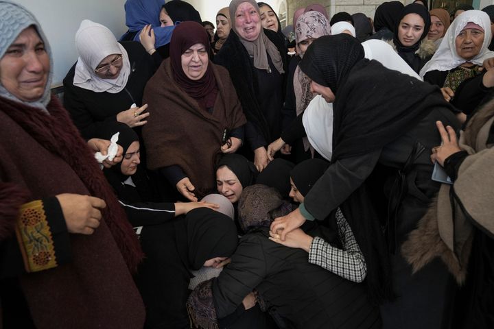 Mourners react during the funeral of Ahed Mohammed, 23, a day after she and another man were killed in clashes with Israeli forces in the West Bank village of Dura. Tuesday, Jan. 16, 2024. The Israeli military said it was reviewing the incident. (AP Photo/Mahmoud Illean)