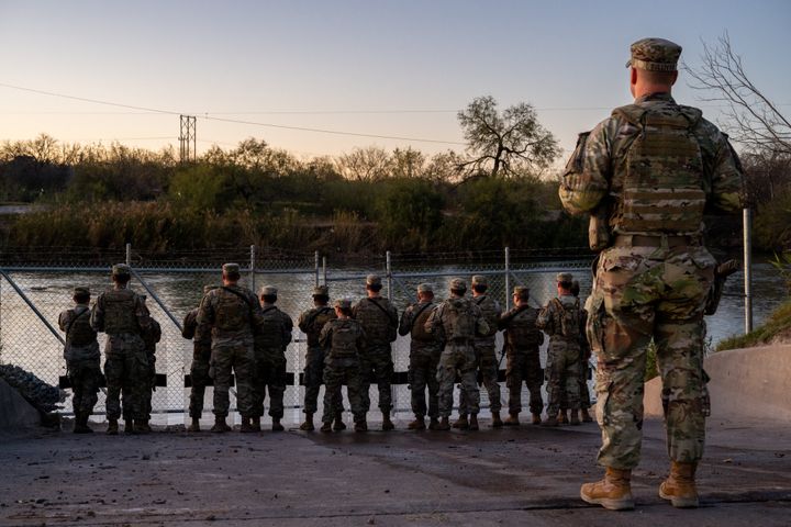 Texas National Guard soldiers stand guard on the banks of the Rio Grande River at Shelby Park in Eagle Pass, Texas, on Jan. 12.