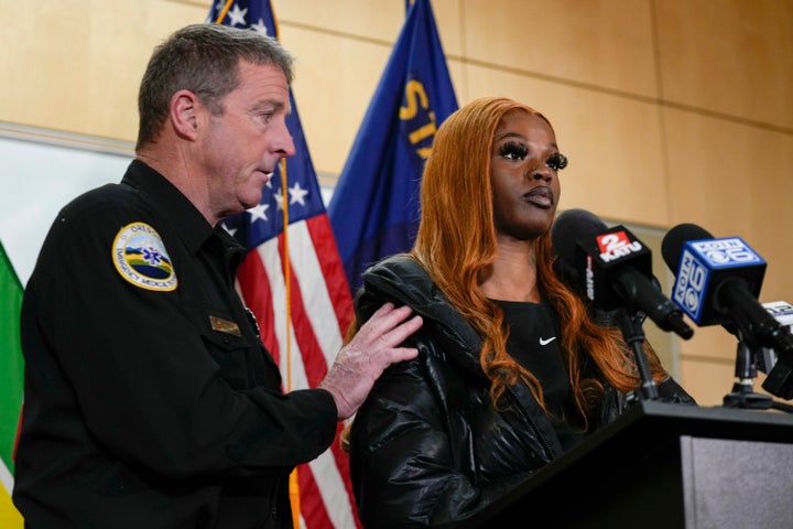 Portland Fire and Rescue spokesman Rick Graves, left, introduces Majiah Washington to speak during a news conference at the Portland Fire & Rescue headquarters on Thursday, Jan. 18, 2024, in Portland, Ore. A power line fell on a parked car in northeast Portland on Wednesday, killing three people and injuring a baby during an ice storm. Washington, who saw the incident unfold through her window, rushed outside to grab the baby from one of the people lying in the street to save its life. (AP Photo/Jenny Kane)