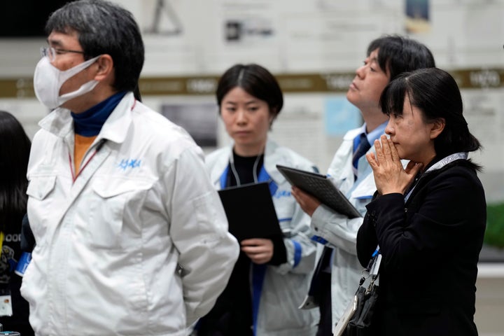 Staff of Japan Aerospace Exploration Agency (JAXA) watch a live streaming of the pinpoint moon landing operation by the Smart Lander for Investigating Moon (SLIM) spacecraft at JAXA's Sagamihara Campus Saturday, Jan. 20, 2024, in Sagamihara near Tokyo. (AP Photo/Eugene Hoshiko)