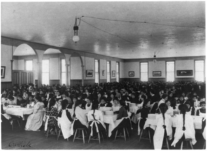 Students eat at the dining hall at Carlisle Indian Industrial School in Pennsylvania in 1901.