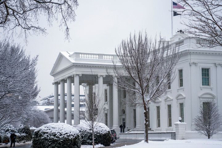 A worker removes snow from the White House driveway during a winter storm, Friday, Jan. 19, 2024, in Washington. (AP Photo/Evan Vucci)