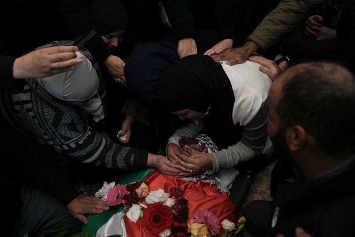 Relatives mourn 17-year-old American Tawfiq Ajaq at his funeral in his family’s Palestinian home village in Al-Mazra'a ash-Sharqiya, West Bank, Saturday, Jan. 20, 2024. Ajaq was killed Friday by Israeli fire and police say they have launched an investigation. (AP Photo/Nasser Nasser)