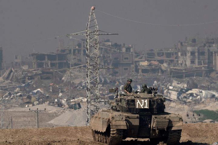 Israeli soldiers overlook the Gaza Strip from a tank, as seen from southern Israel, Friday, Jan. 19, 2024. (AP Photo/Maya Alleruzzo)