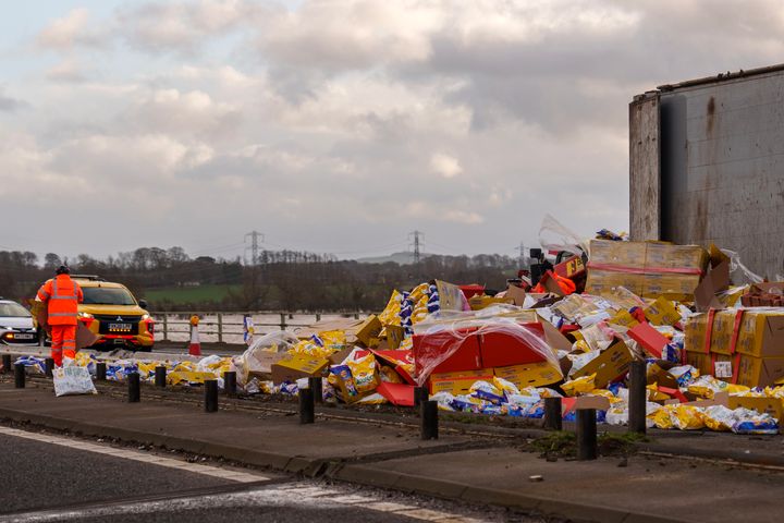 CARLISLE: Workers clear up Wotsits and Quavers savoury snacks from the M6 motorway northbound after the wind overturned lorries on the carriageway.