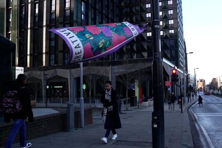 LONDON: People walk past a poster blown by the wind, on a street in London.