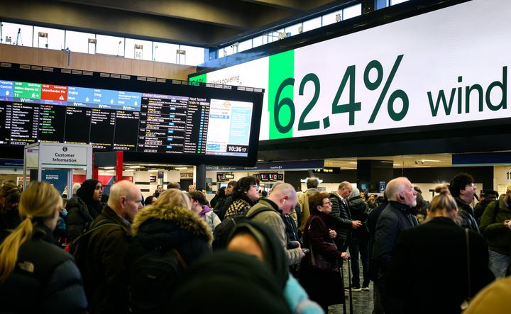 LONDON: A digital display indicates the UK's current use of wind energy, as travellers wait to board delayed and re-arranged trains at Euston Station.