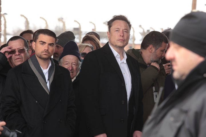 Tesla and SpaceX's CEO Elon Musk, center, walks during his visit to the site of the Auschwitz-Birkenau Nazi German death camp in Oswiecim, Poland, on Monday, Jan. 22, 2024. (AP Photo/Andrzej Rudiak)