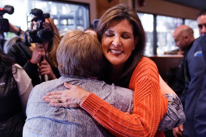 Republican presidential candidate former UN Ambassador Nikki Haley embraces a patron during a campaign stop at a brewery, Monday, Jan. 22, 2024, in Manchester, N.H. (AP Photo/Charles Krupa)