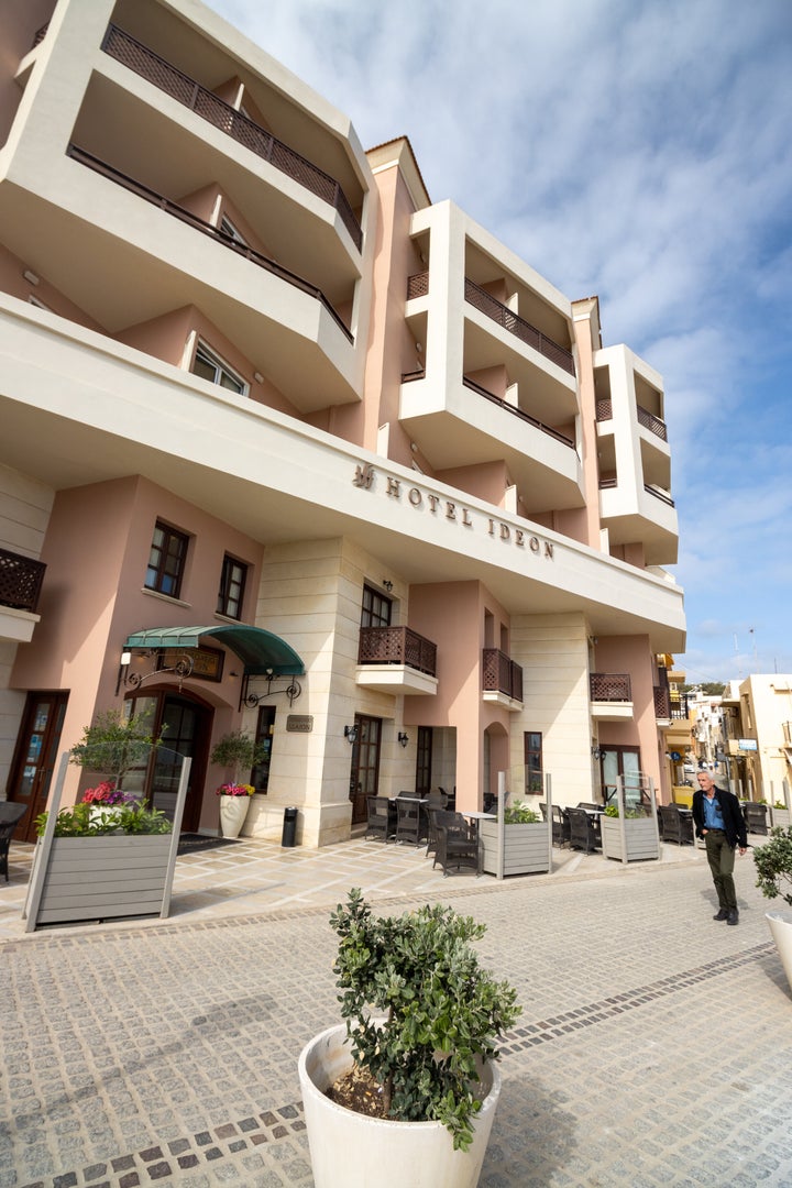 Hotel Ideon at Rethymnon Town on Crete, Greece, with a man in the background.