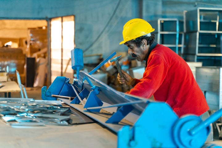 Portrait of senior worker working at construction site