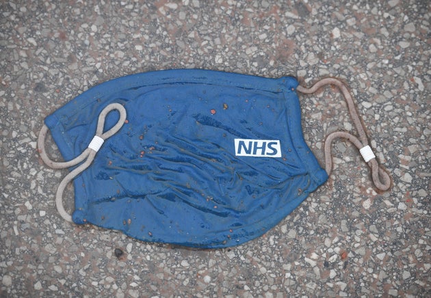 A face mask bearing an NHS logo.