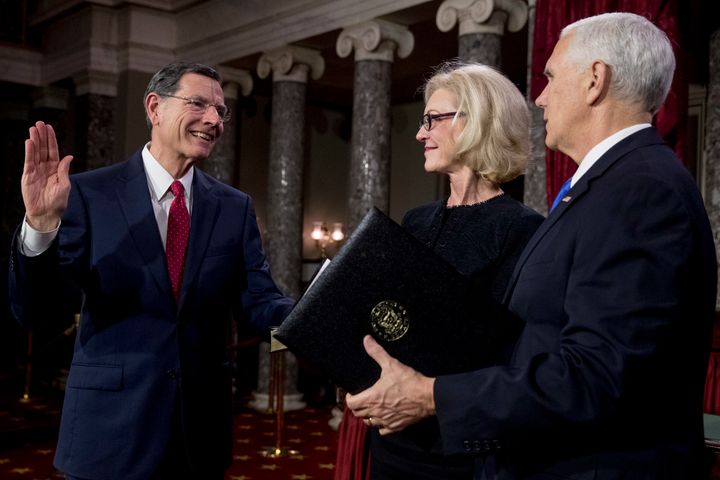 Then-Vice President Mike Pence (right) administers the Senate oath of office to Sen. John Barrasso, accompanied by wife Bobbi Barrasso, in 2019.