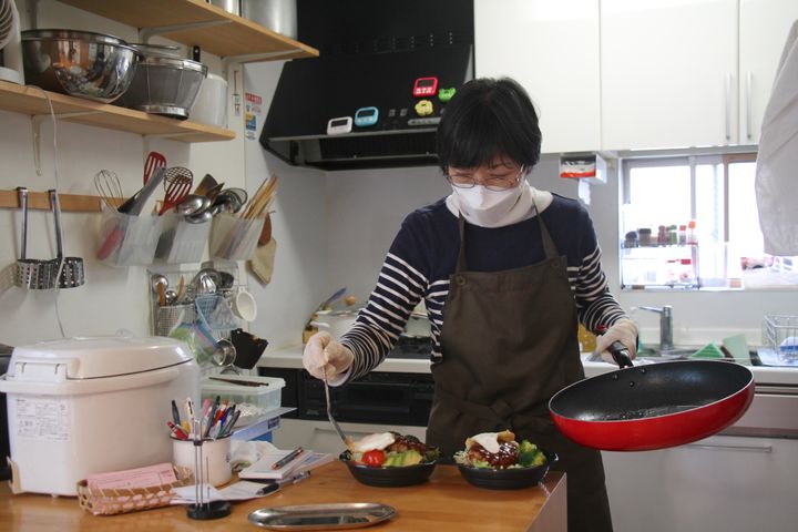 カフェのキッチンでロコモコ丼を作る小林さん