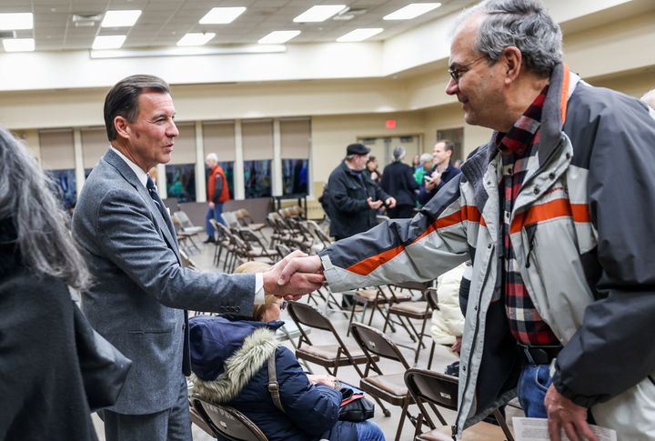 Former Rep. Tom Suozzi, left, speaks to a voter at a Jan. 11 town hall. He has blasted Mazi Pilip for limiting media access to her and public scrutiny of her positions.