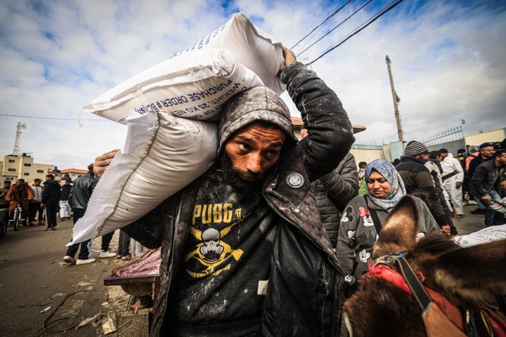 Displaced Palestinians receive food aid at the United Nations Relief and Works Agency for Palestine Refugees (UNRWA) center in Rafah in the southern Gaza Strip on January 28, 2024, amid ongoing battles between Israel and the Palestinian militant group Hamas. Israel has alleged several UNRWA staff were involved in Hamas's October 7 attack, leading some key donor countries to suspend funding and the agency to fire several staff over the claims.