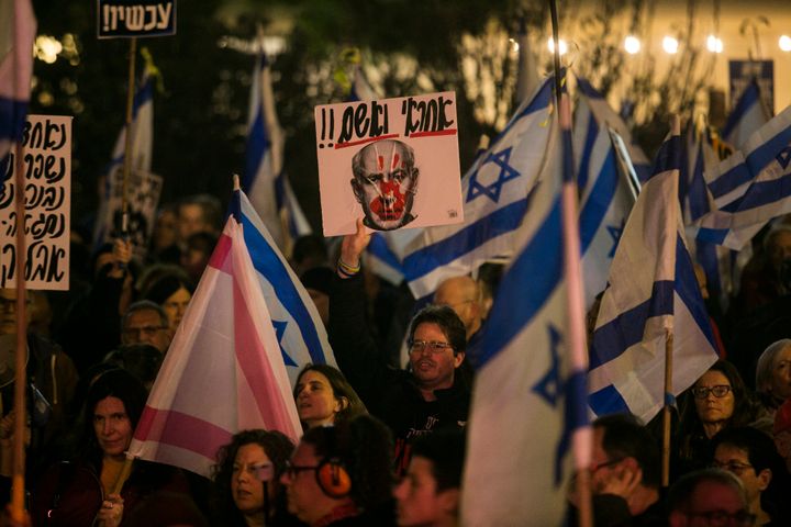 Protesters hold signs and flags during a demonstration against Israeli Prime Minister Benjamin Netanyahu and the Israeli government on January 27, 2024 in Tel Aviv, Israel. According to Israel, 132 hostages are still held by Hamas in Gaza since the Oct. 7 attack.