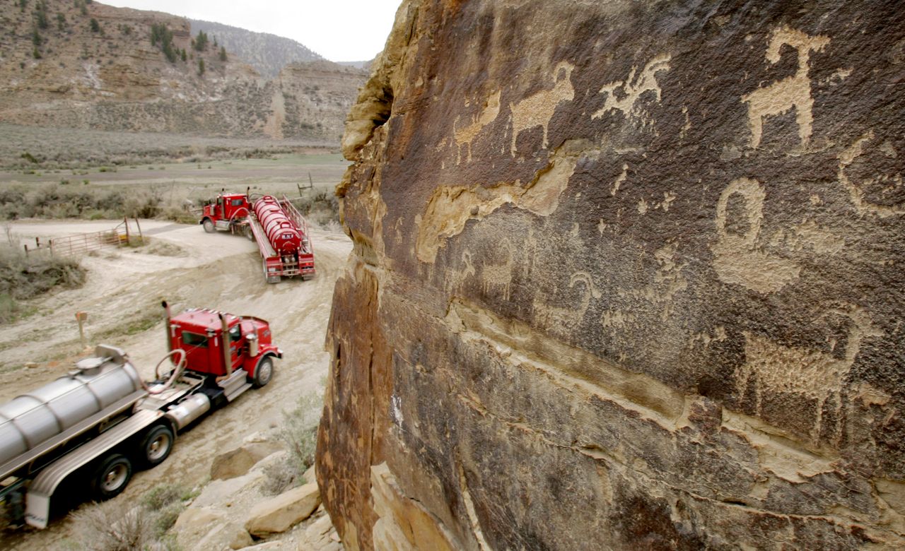 In this 2008 file photo, tanker trucks pass petroglyphs in Nine Mile Canyon northeast of Wellington, Utah.