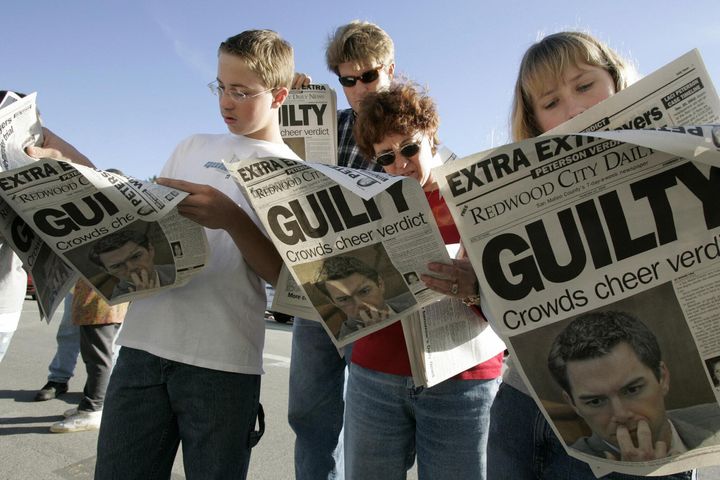 People read an extra edition put out by the Redwood City Daily News after the verdict was announced in the Scott Peterson murder trial on Nov. 12, 2004, in Redwood City, California. Peterson was found guilty of one count of first-degree and one count of second-degree murder of his wife Laci Peterson and the couple's unborn son. 