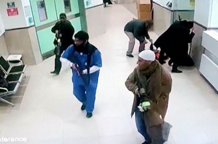 In this image taken from surveillance video provided by the Palestinian Health Ministry, Israeli forces disguised as civilians and medical workers hold weapons in a hallway at the Ibn Sina Hospital in the West Bank town of Jenin