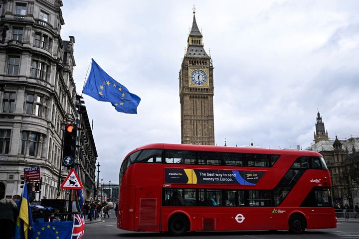 An EU flag, flown by anti-Conservative and anti-Brexit activists, flaps in the air in front of Big Ben.