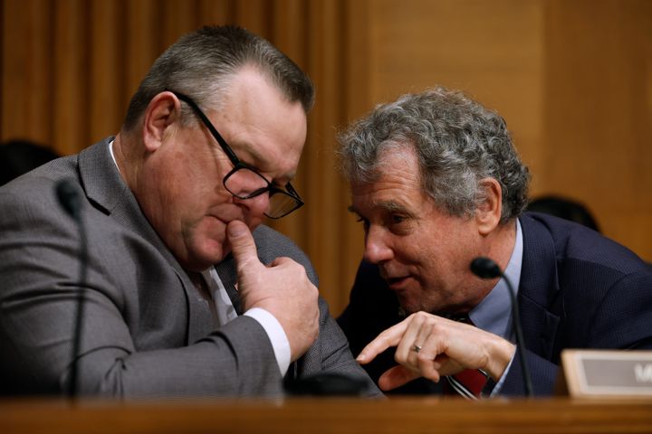 Sen. Sherrod Brown (D-Ohio), right, talks with Sen. Jon Tester (D-Mont.) during a Senate Banking Committee hearing. The two men are Republicans' top targets in the Senate.