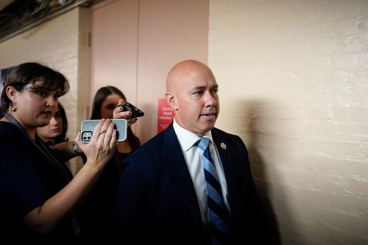 Rep. Brian Mast, R-Fla., speaks with reporters as he arrives for the Republican caucus meeting at the Capitol in Washington, Thursday, Oct. 19, 2023.