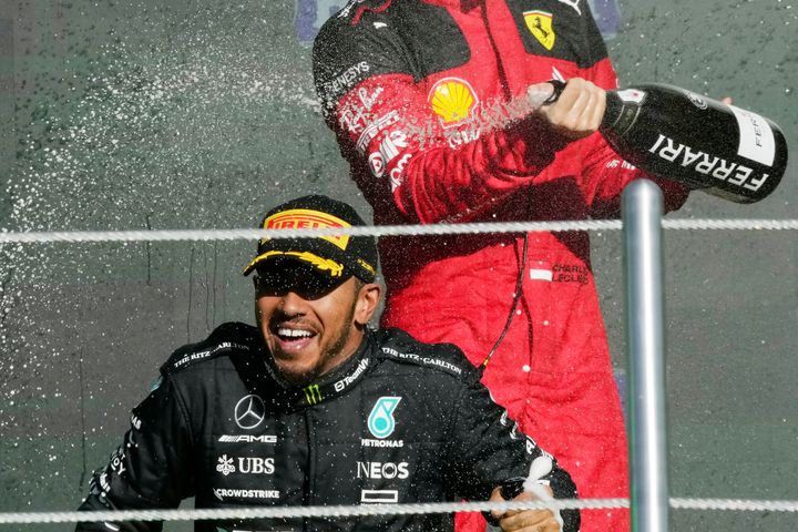 Mercedes driver Lewis Hamilton, bottom, is sprayed with champagne by Ferrari driver Charles Leclerc on the podium for the Formula One Mexico Grand Prix in Mexico City, Sunday, Oct. 29, 2023. Hamilton is making a shocking move from Mercedes to Ferrari next year.