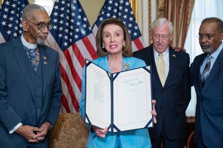 Then-House Speaker Nancy Pelosi is photographed holding up bill, the "Emmett Till Antilynching Act," next to former congressman Bobby Rush, congressman Steny Hoyer and Joe Madison during a signing ceremony on Capitol Hill in Washington, Wednesday, March 16, 2022.