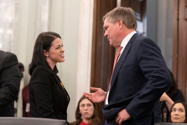 Norfolk Southern CEO Alan Shaw talks to East Palestine, Ohio, resident Misti Allison on March 22, 2023, at a Senate committee hearing on improving rail safety in response to the East Palestine train derailment.