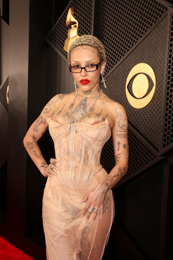 Doja Cat wore a see-through, ultra low-cut corseted gown by Dilara Findikoglu to the 66th Grammy Awards on Sunday in Los Angeles, California.