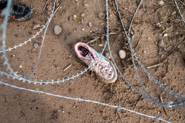 Razor wire and a shoe are seen near the Rio Grande at Shelby Park on Feb. 3 in Eagle Pass, Texas.