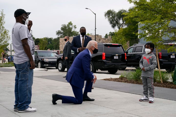 Biden visits with relatives of a store owner as he arrives to shop for his grandchildren in Detroit on Sept. 9, 2020.