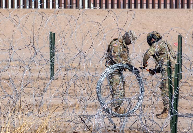 U.S. Border Patrol officers cut through razor wire near Ciudad Juarez, Mexico, on Jan. 31. 