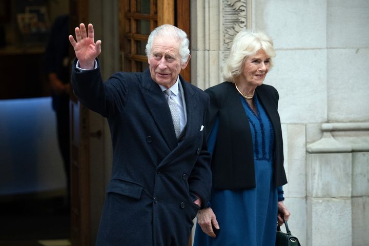 King Charles III waves as he departs with Queen Camilla after receiving treatment for an enlarged prostate at The London Clinic on January 29.