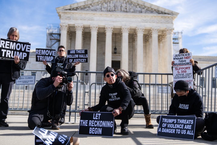 Demonstrators gather Thursday at the U.S. Supreme Court building as oral arguments are heard in the case of whether Colorado could keep former President Donald Trump's name off its 2024 presidential ballot because of his efforts to overturn the 2020 election.