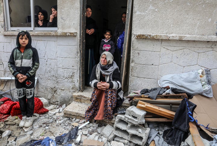 Palestinians survey the aftermath Friday from Israeli attacks in Rafah in the Gaza Strip. A building targeted in the attack and structures around it were damaged.