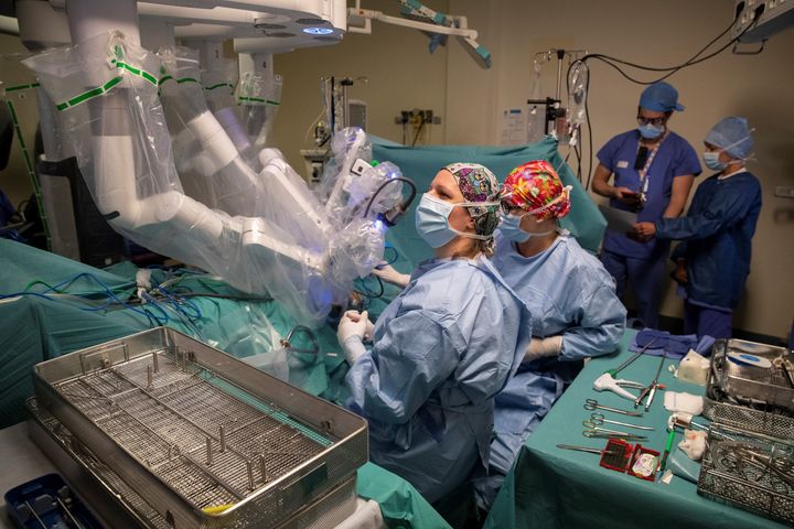 Surgeons carry out an operation using a da Vinci robotic surgical system.