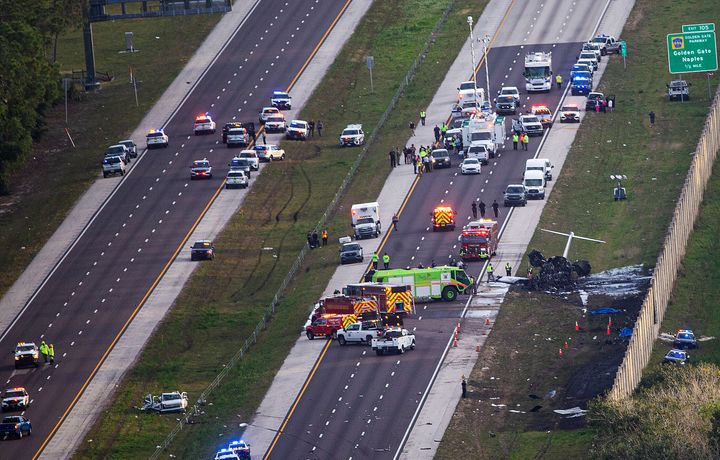 Emergency officials work the scene of a small plane crash on Interstate 75 in Naples, Fla., near Exit 105, Friday, Feb. 9, 2024. Two people were confirmed dead. (Andrew West/The News-Press via AP)