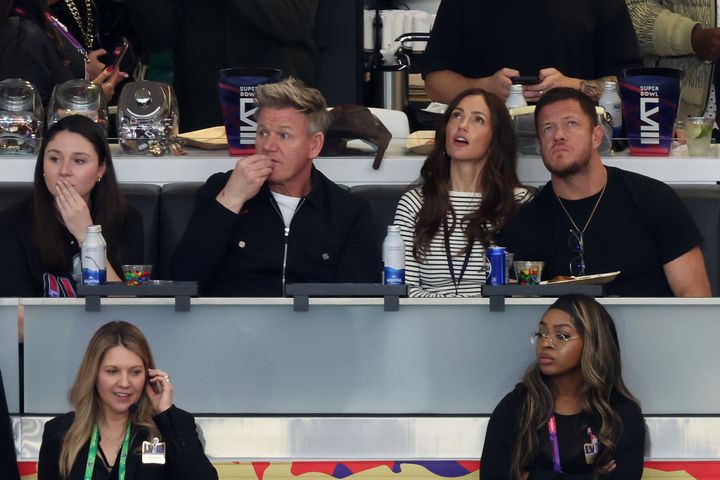 (Left to right) Celebrity chef Gordon Ramsay, actress Minka Kelly and singer/songwriter Dan Reynolds look on in the first quarter.
