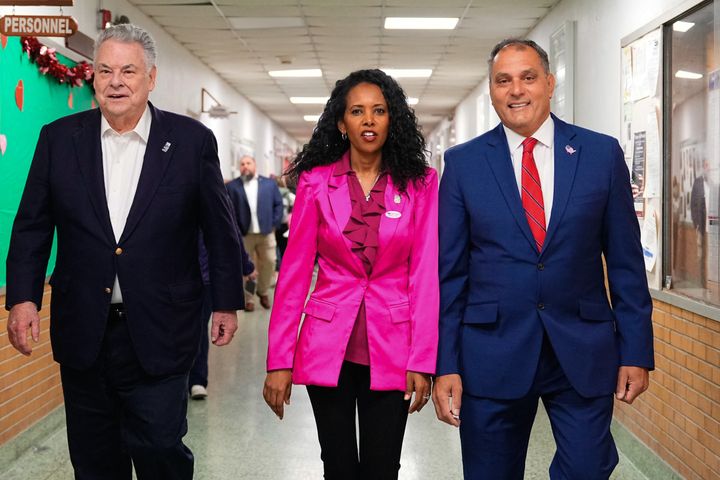 Pilip, center, walks alongside former Rep. Peter King (R-N.Y.), left, and Town of Oyster Bay Supervisor Joseph Saladino after voting early in Massapequa, New York, on Friday.