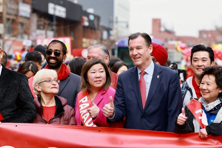 Rep.-elect Tom Suozzi (D-N.Y.), third from right, marches in the Lunar New Year parade on Saturday in Flushing, Queens, alongside Rep. Grace Meng (D-N.Y.).