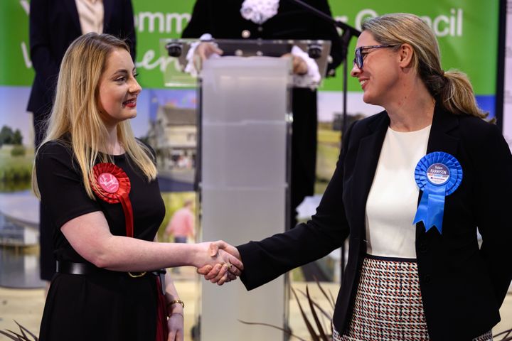 KETTERING, ENGLAND - FEBRUARY 16: (L-R) Labour Party candidate Gen Kitchen shakes hands with Conservative Party candidate Helen Harrison after being declared the winner in the Wellingborough by-election at the count centre in Kettering Leisure Village on February 16, 2024 in Kettering, England. The Wellingborough by-election takes place after a recall petition that removed the incumbent Conservative MP Peter Bone. Bone broke the MPs' code of conduct on four counts of bullying and one of sexual misconduct. On the ballot paper is Conservative Helen Harrison, partner of Peter Bone, Labour Gen Kitchen, Ana Savage Gun for Liberal Democrats and Ben Habib for the Reform Party among others. (Photo by Leon Neal/Getty Images)