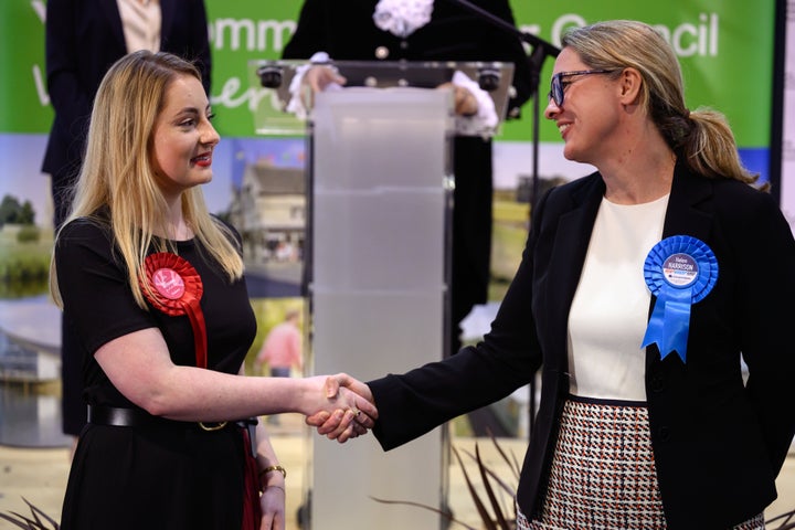 KETTERING, ENGLAND - FEBRUARY 16: (L-R) Labour Party candidate Gen Kitchen shakes hands with Conservative Party candidate Helen Harrison after being declared the winner in the Wellingborough by-election at the count centre in Kettering Leisure Village on February 16, 2024 in Kettering, England. The Wellingborough by-election takes place after a recall petition that removed the incumbent Conservative MP Peter Bone. Bone broke the MPs' code of conduct on four counts of bullying and one of sexual misconduct. On the ballot paper is Conservative Helen Harrison, partner of Peter Bone, Labour Gen Kitchen, Ana Savage Gun for Liberal Democrats and Ben Habib for the Reform Party among others. (Photo by Leon Neal/Getty Images)