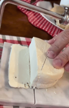 A marble board wire cheese cutter that's half decor, half kitchen tool